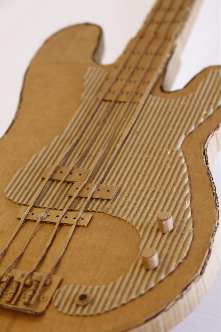 an unfinished wooden guitar sitting on top of a table