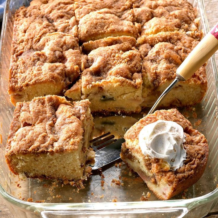 a close up of a cake in a pan on a table with a knife and fork