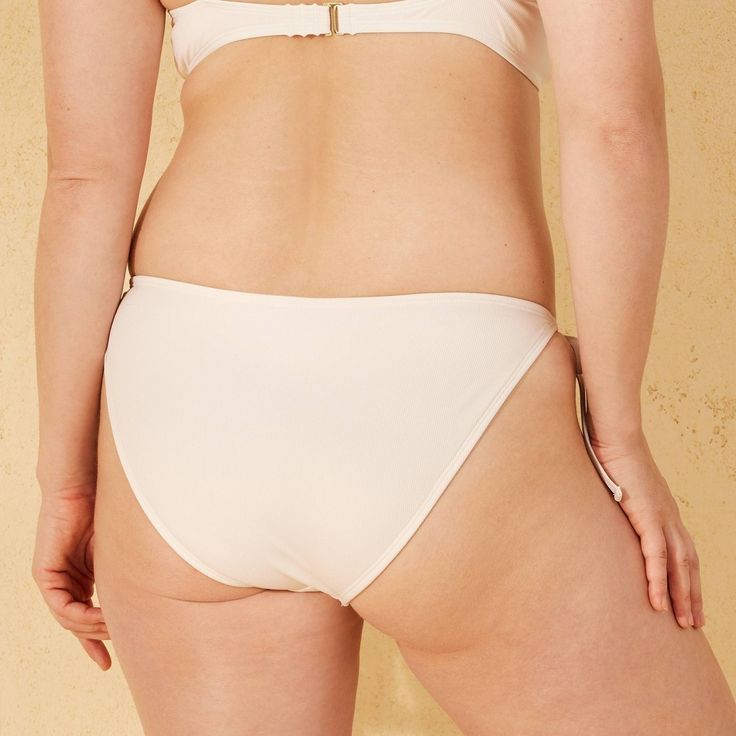 This Ribbed Low-Rise Cheeky String Bikini Bottom from Shade & Shore™ makes a flattering addition to your swim separates. Made from recycled polyester with spandex and full lining, this low-rise bikini bottom is designed in a figure-flattering cheeky cut. Great for pairing with a variety of bikini tops, it also features side string ties for an adjustable, stay-put fit. Shade & Shore™: Made for the sun & fit for fun. Seamless Tie-side Bottoms For Sunbathing, Seamless Tie-side Bottoms For Poolside, Seamless Tie-side Bottoms For Pool, Seamless Tie-side Pool Bottoms, Beach Bottoms With Bra-friendly Tie-side, Beach Bottoms With Tie-side And Bra-friendly Design, Beach Bottoms With Tie-sides, Bra Friendly, Poolside Swimwear With Lined Body And Tie-side Bottom, Swimwear With Moderate Back And Tie-side Bottom For Poolside