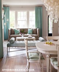 a living room filled with furniture and a white table