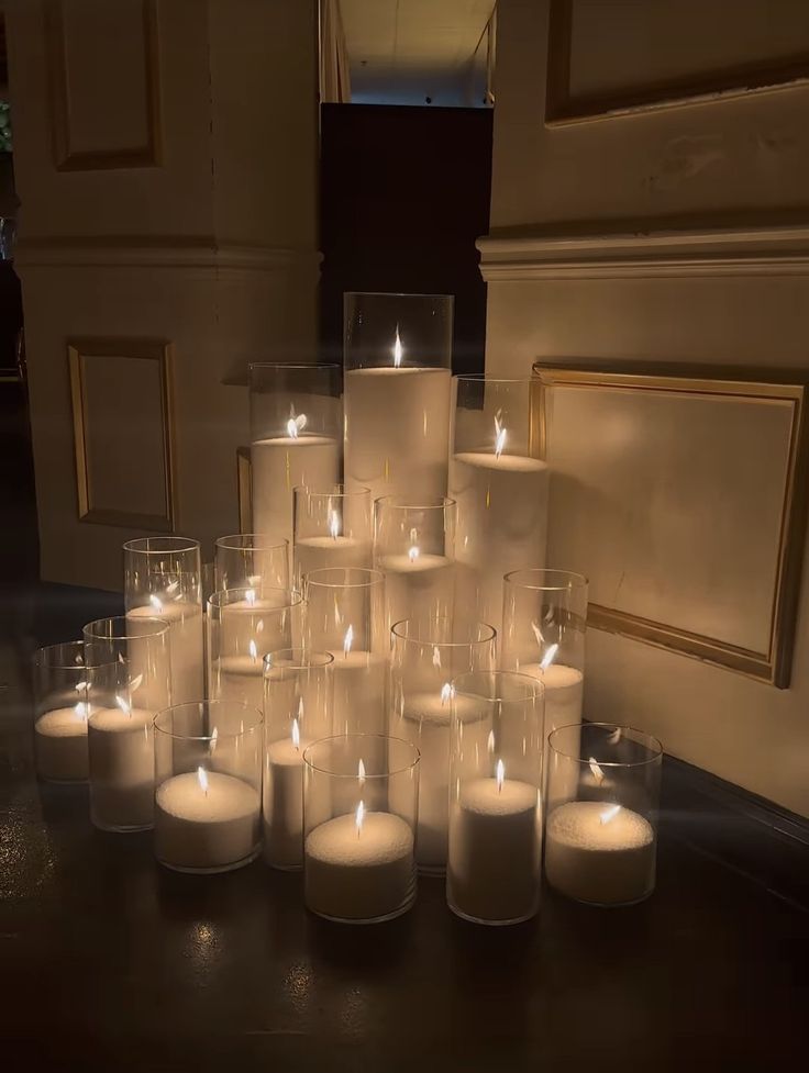 a bunch of lit candles sitting on top of a table