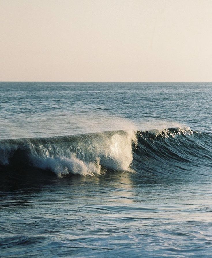 a man riding a wave on top of a surfboard