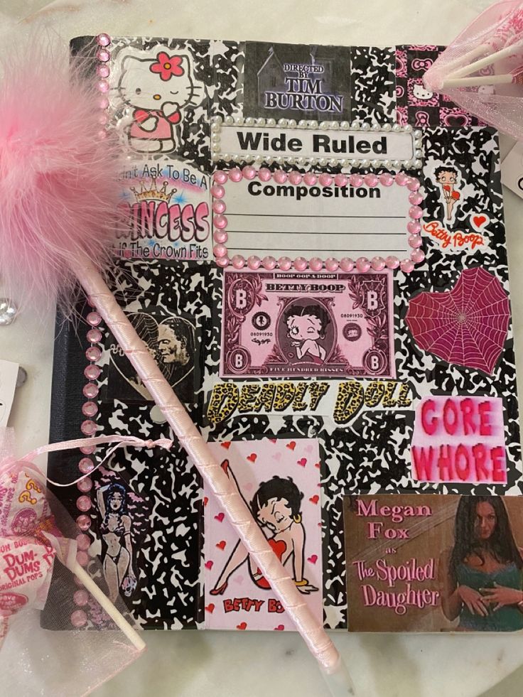 the contents of a notebook are laid out on a table with pink and black decorations