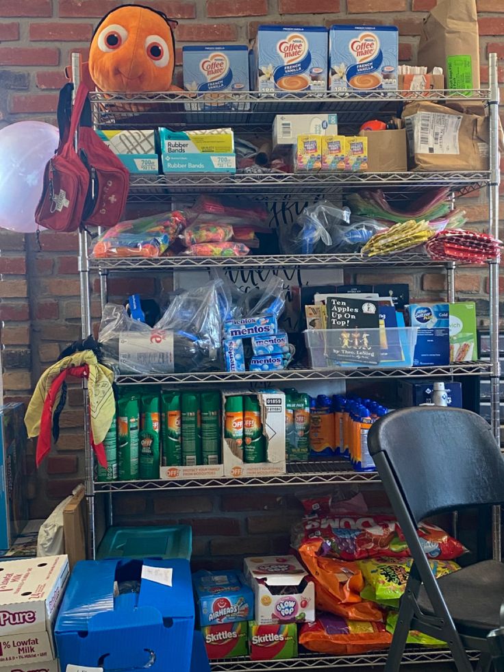 the shelves are full of snacks and other items for sale in front of a brick wall