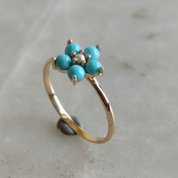 This stunning ring is set in 14k Solid Yellow Gold with Natural Arizona Turquoise and Pearl with utmost precision. It is an unique statement gemstone ring for nearly every occasion and is completely hassle-free jewelry. ITEM DETAILS * GEM: Arizona Turquoise * GEM SIZE: 3 mm * GEM SHAPE: Round * GEM: Pearl * GEM SIZE: 2 mm * GEM SHAPE: Round * TOTAL GEM WEIGHT: 0.50 carats * Gold Purity: 14KT * Gold Weight: 1.22 gram * Total Weight of the Ring: 1.32 gram The Gold purity is guaranteed and it comes Hallmarked Turquoise Ring Fine Jewelry, Hallmarked Turquoise Fine Jewelry Ring, 14k Gold Multi-stone Turquoise Jewelry, Turquoise Multi-stone 14k Gold Jewelry, Gift Turquoise Cluster Ring With Gemstone, Fine Jewelry Turquoise Ring In Yellow Gold As Gift, 14k Gold Turquoise Ring For Anniversary, Fine Jewelry 14k Gold Turquoise Wedding Ring, Fine Jewelry 14k Gold Turquoise Ring For Wedding