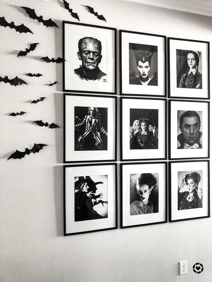 black and white photograph of halloween pictures on the wall with bats hanging from it's sides