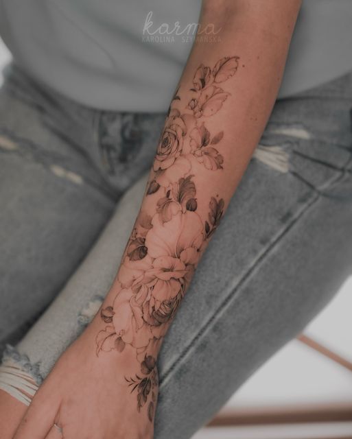 a woman's arm with flowers on it