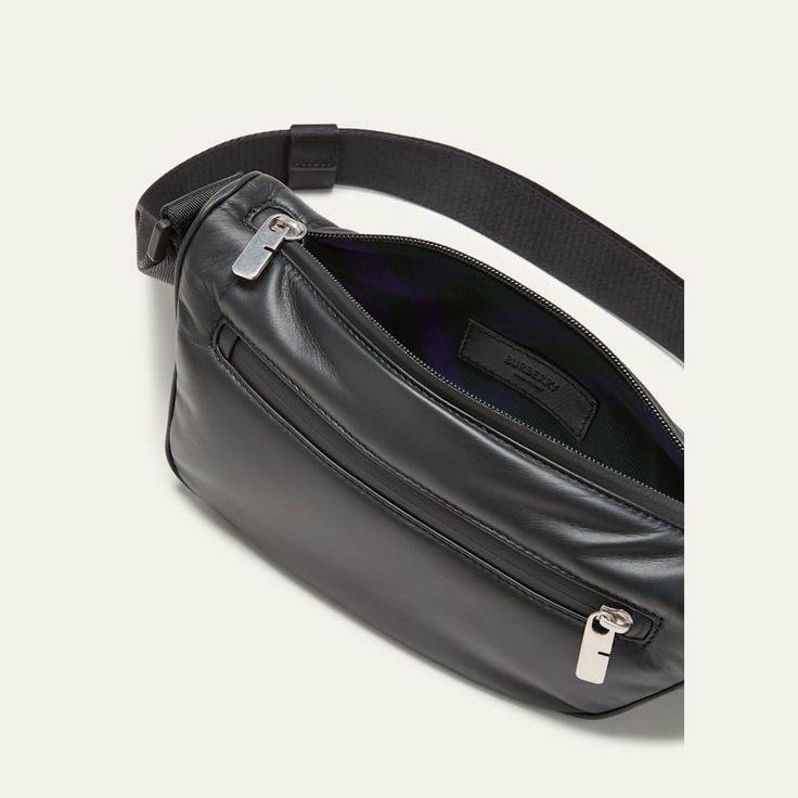 Burberry crossbody bag in smooth calf leather Features a folded shield shape and clip inspired by the equestrian knight design Adjustable webbing shoulder strap; approx. 23.6" drop Zip closure Exterior, one zip pocket Hand-painted edges Brushed metal hardware Embossed equestrian knight design Approx. 5.3"H x 10.6"W x 3.0"D Made in Italy Designer Leather Belt Bag For Travel, Luxury Belt Bag With Zipper Closure, Luxury Leather Belt Bag With Zipper, Luxury Leather Belt Bag With Zipper Closure, Travel Crossbody Belt Bag With Gunmetal Hardware, Gunmetal Hardware Crossbody Belt Bag For Travel, Luxury Crossbody Belt Bag For Business, Classic Crossbody Belt Bag With Smooth Grain, Classic Smooth Grain Crossbody Belt Bag