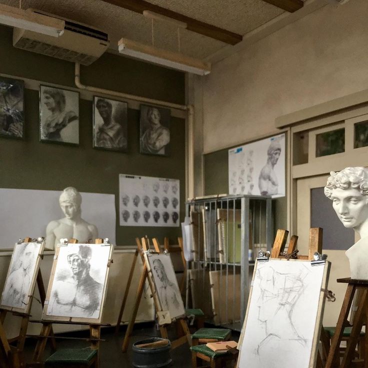 an artist's studio with paintings and sculptures on easels in the foreground