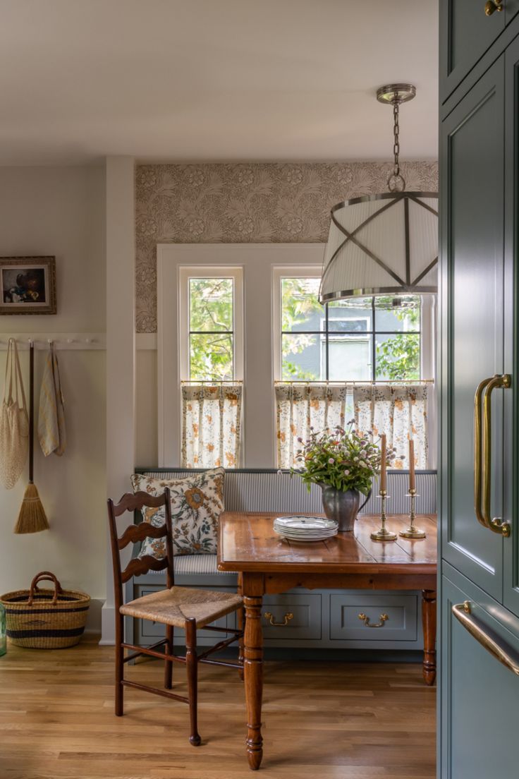 a dining room table and chairs in front of a window with wooden flooring next to it