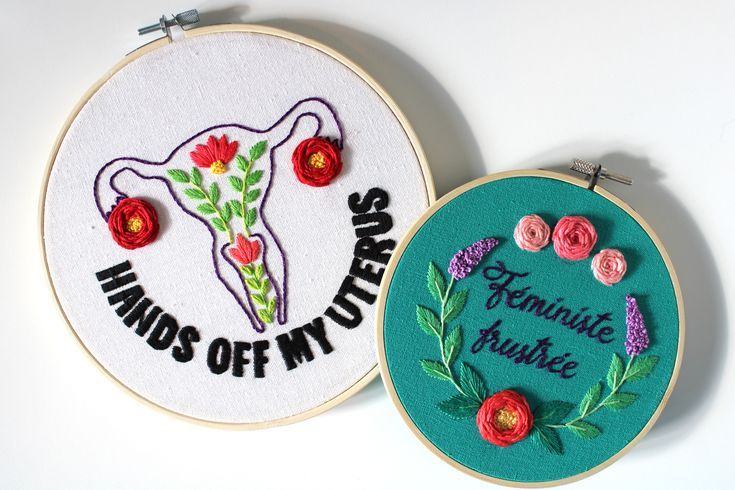 two hand embroidered hoops with flowers and words on them, one is saying hands off my purse