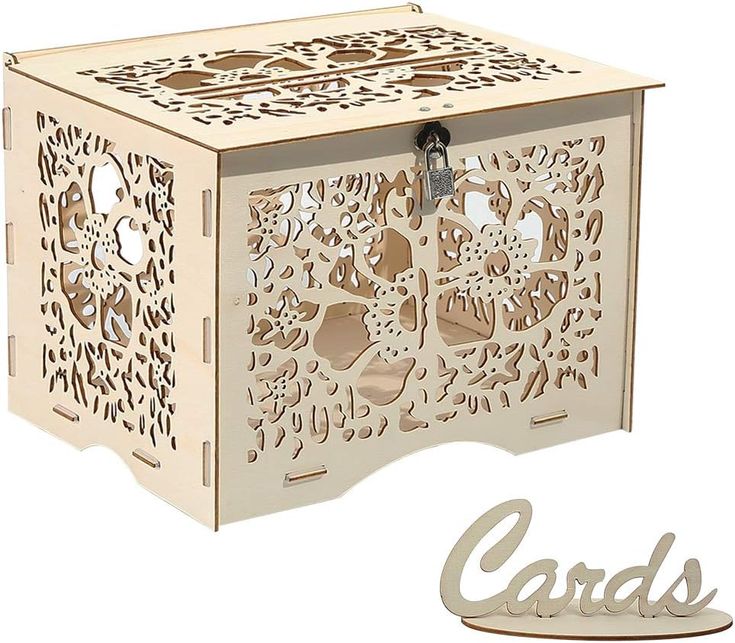 a wooden box with cut out designs on the front and sides, sitting next to a card holder