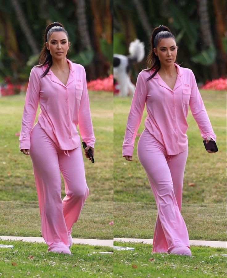 two women in pink outfits walking on the grass