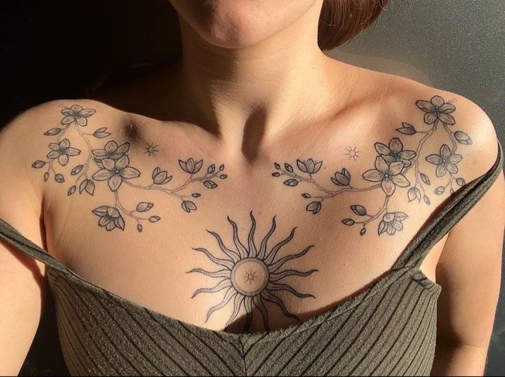 a woman with sun and flowers on her chest