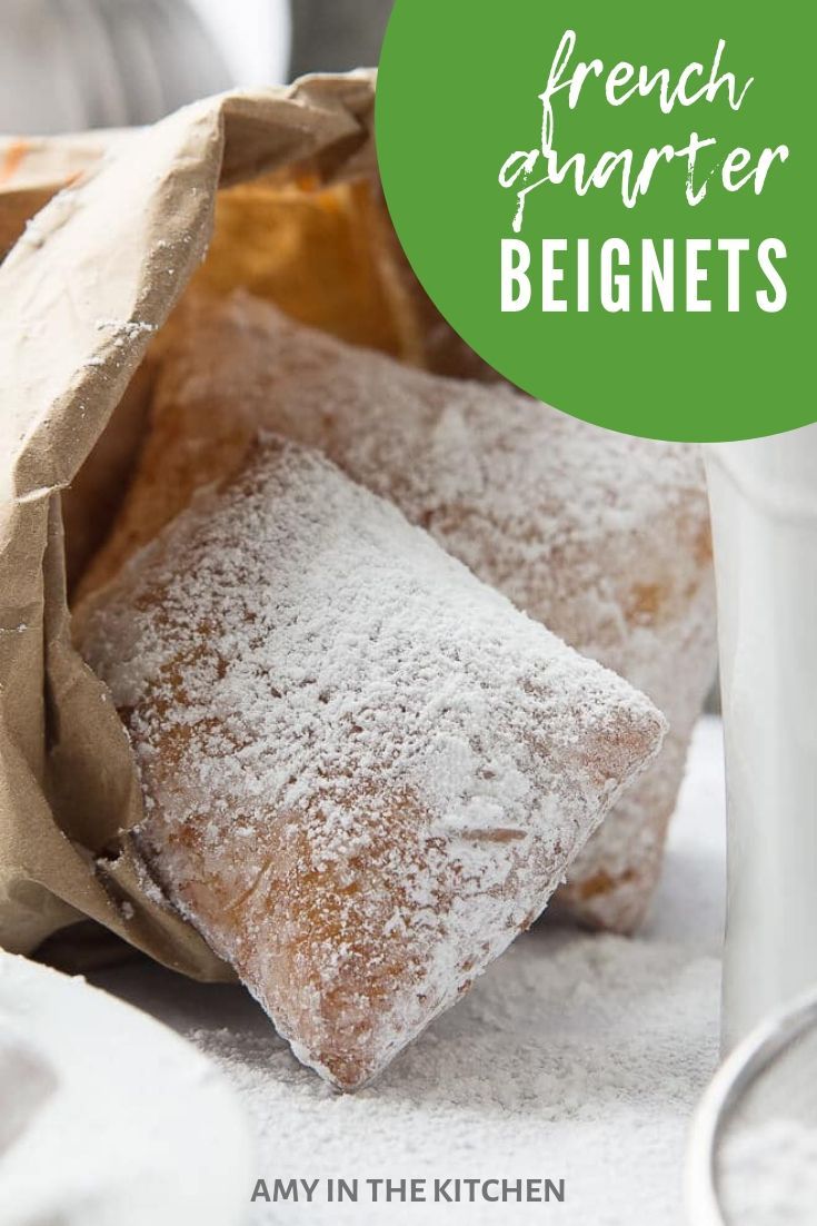 french quartered beignets are sitting on a table next to a cup and napkin