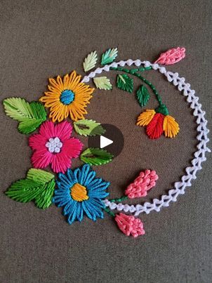 the colorful flowers are made out of crocheted yarns and beads, along with an arrow