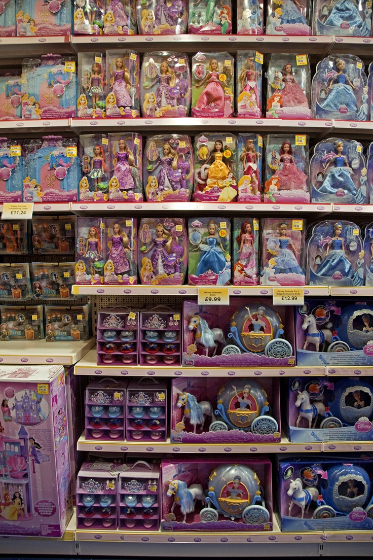 there are many princess toys on display in this toy store, including dolls and figurines