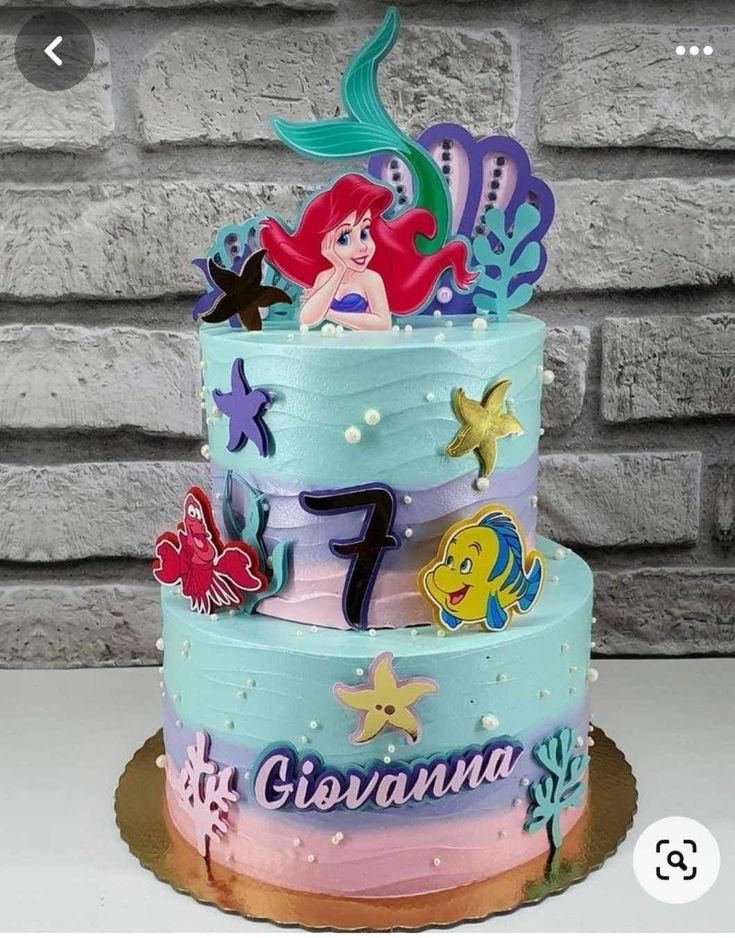 the little mermaid cake is decorated with fondant