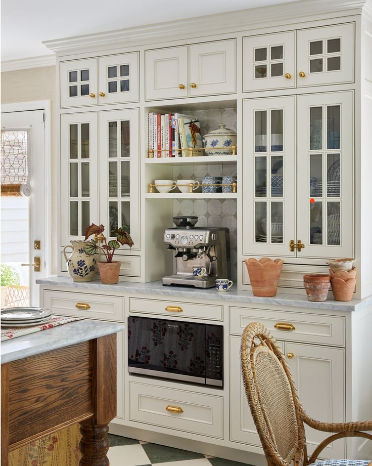 a kitchen with white cabinets and black and white checkered flooring on the floor