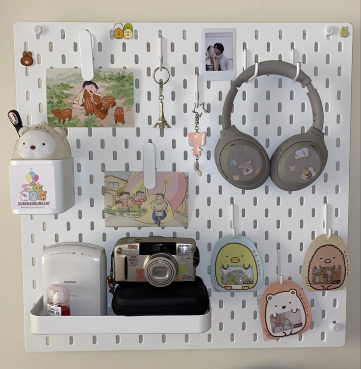 there are many items on the pegboard with ear phones and other things attached to it