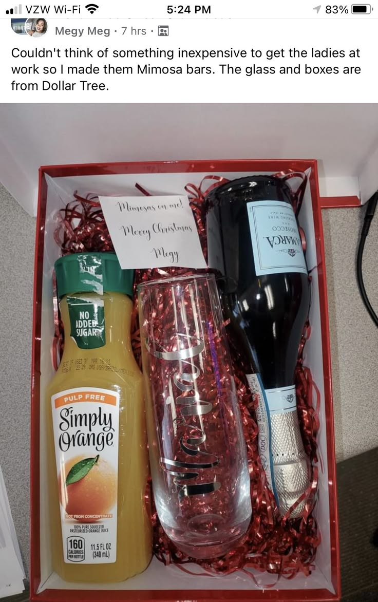 an open red box containing two bottles of orange juice and some other condiments