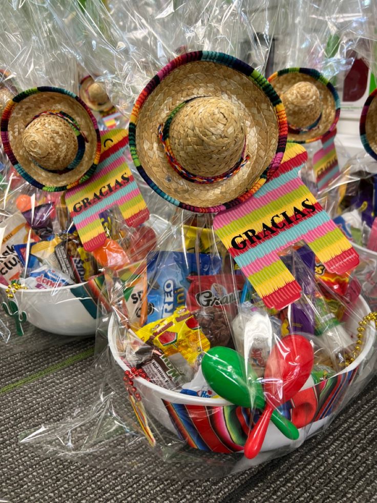 two baskets filled with candy and straw hats