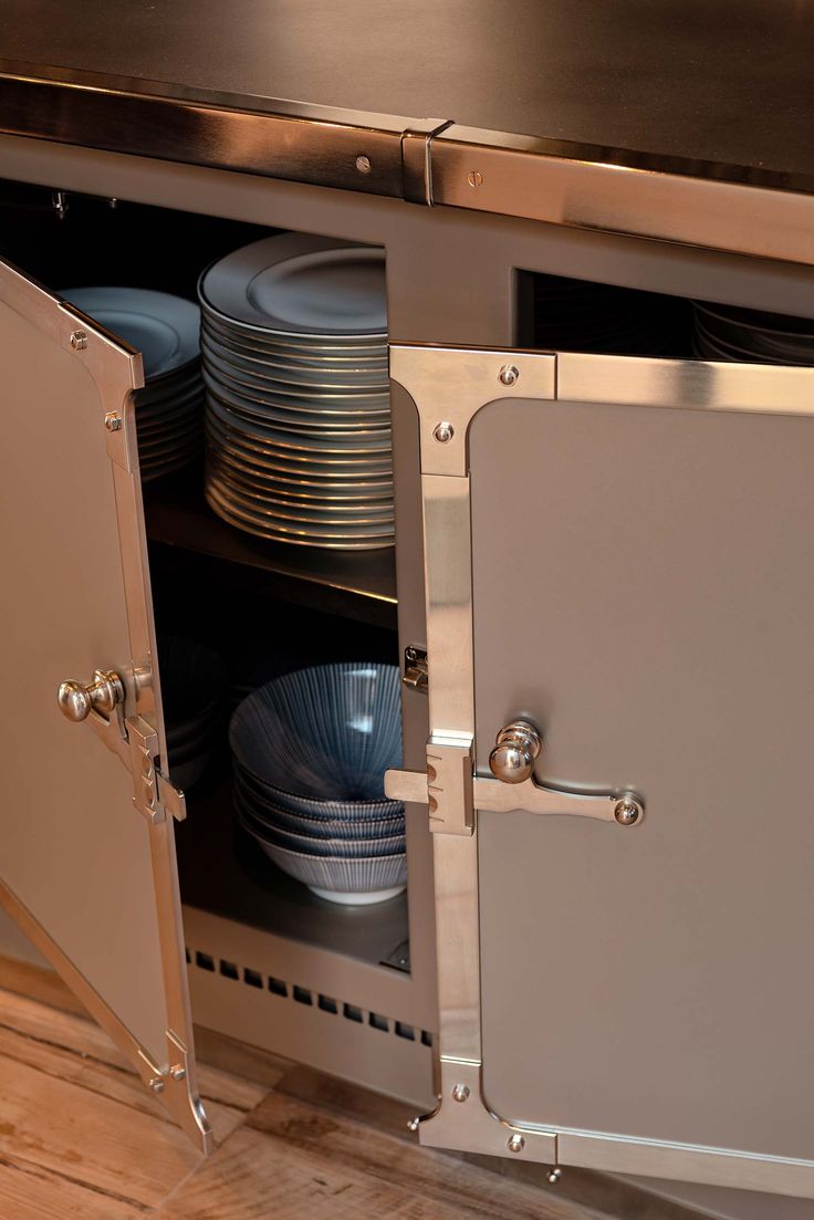 an open cabinet with plates and bowls in it