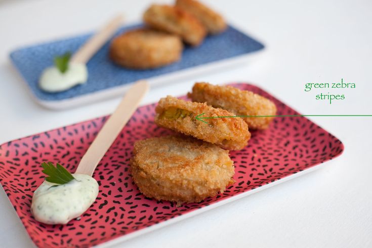 some fried food is on a plate with dip and toothpicks next to it