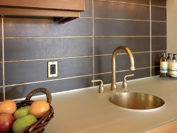 a kitchen sink with a basket of fruit on the counter next to it and soap dispenser