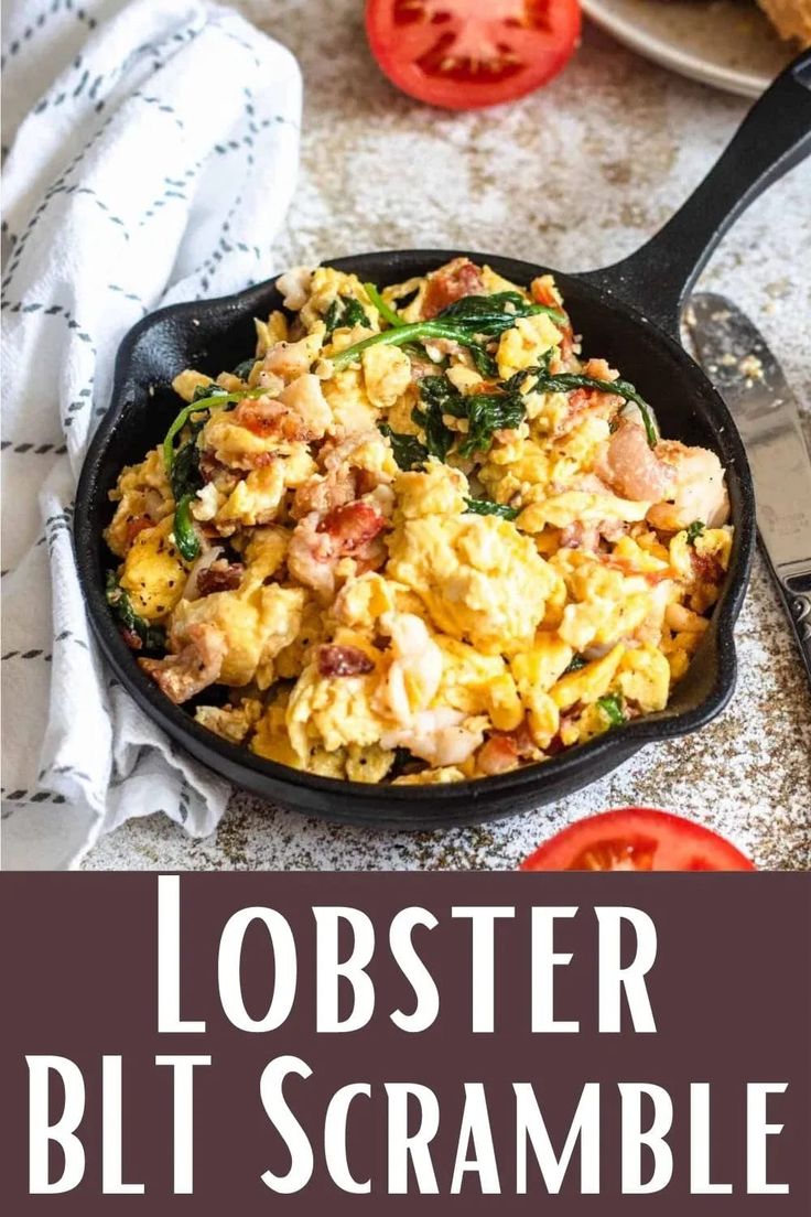 a skillet filled with scrambled eggs and spinach on top of a white table