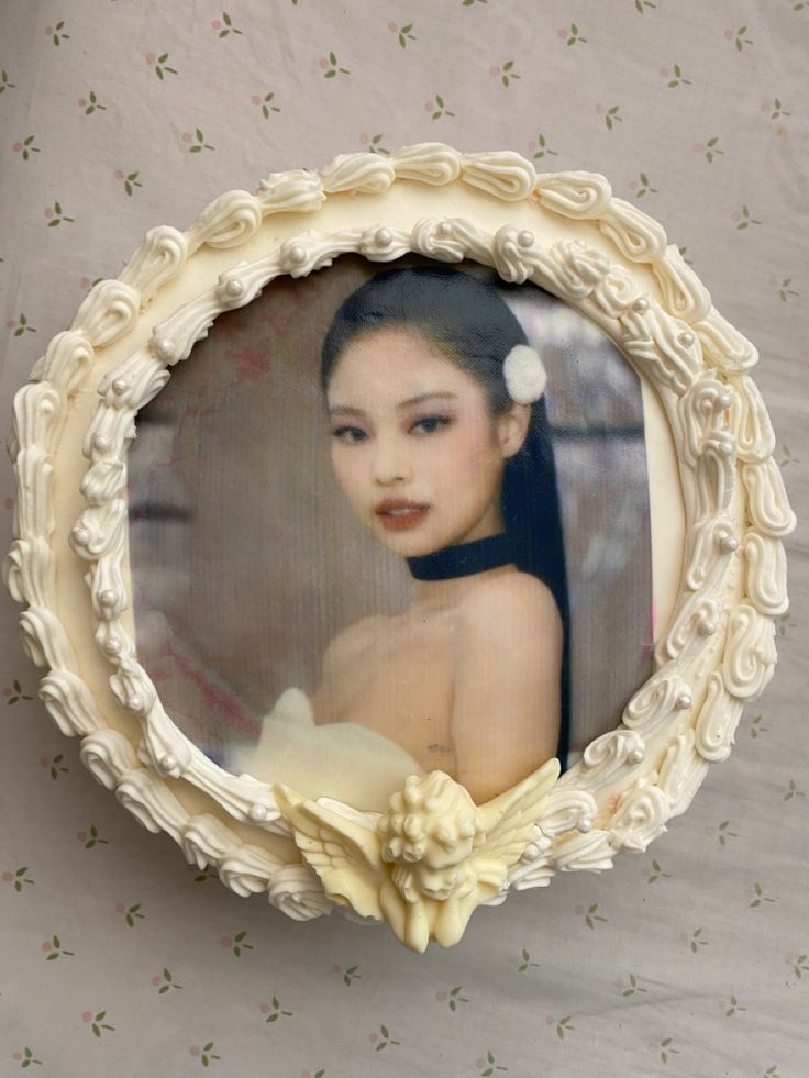 an oval photo frame with a woman's face in it