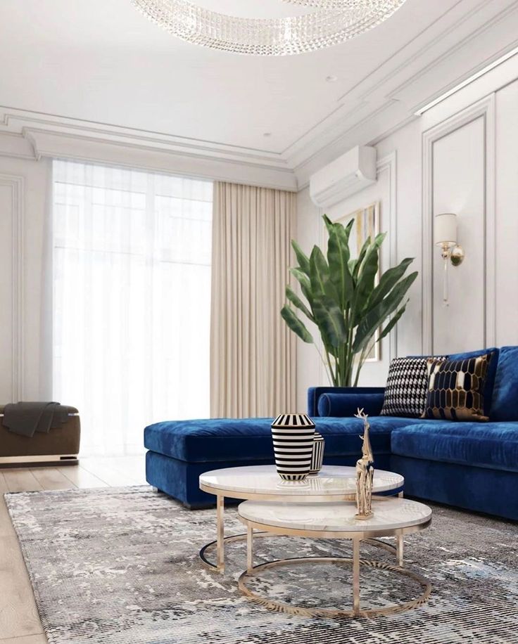 a living room filled with blue couches and a white coffee table