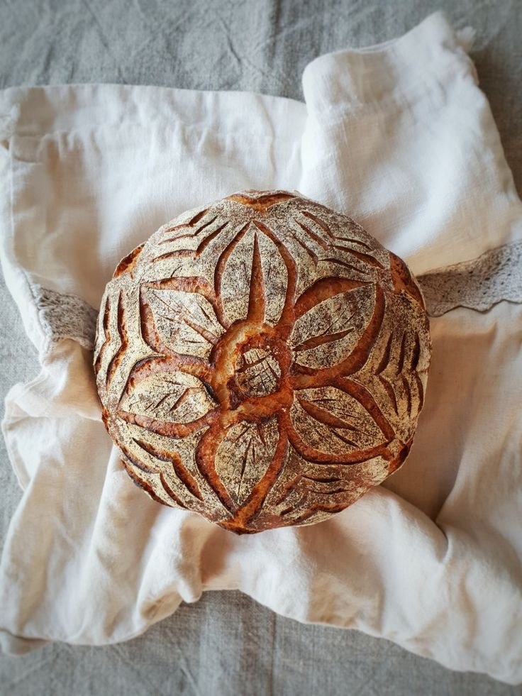 a loaf of bread sitting on top of a white cloth