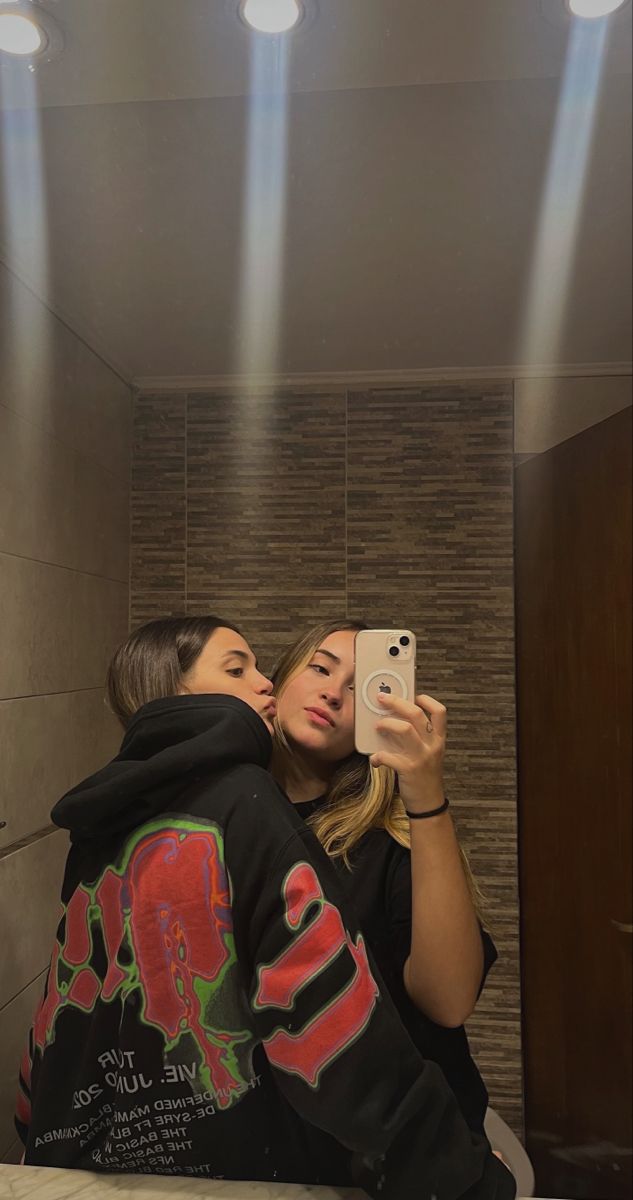 two women are taking a selfie in the bathroom while they both have their faces close together