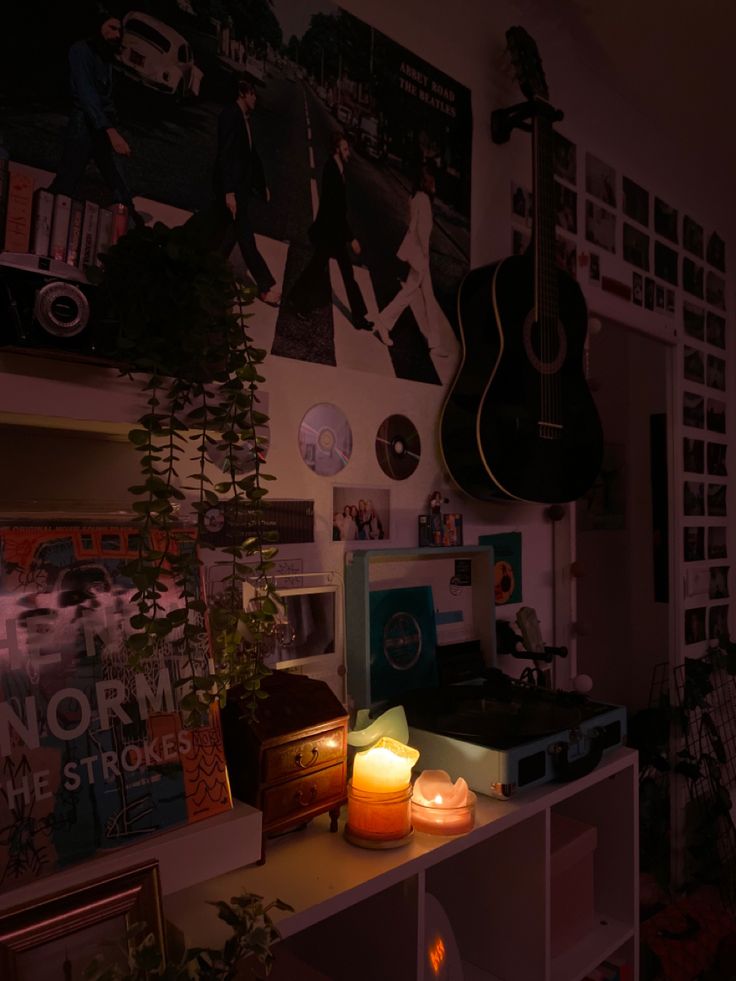 a room filled with lots of different types of decorations and lights on the wall next to a guitar