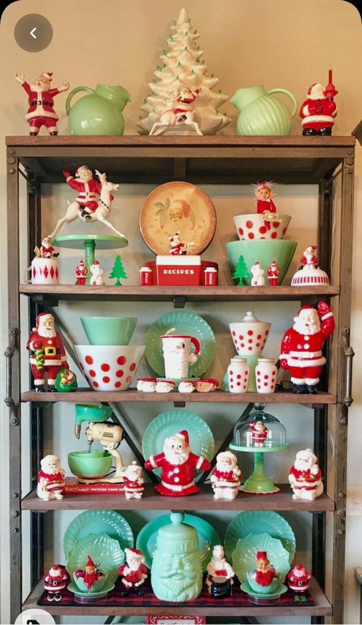 a shelf filled with lots of christmas dishes and figurines on top of it