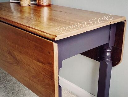 a wooden desk with one drawer open on the top and two drawers closed at the bottom