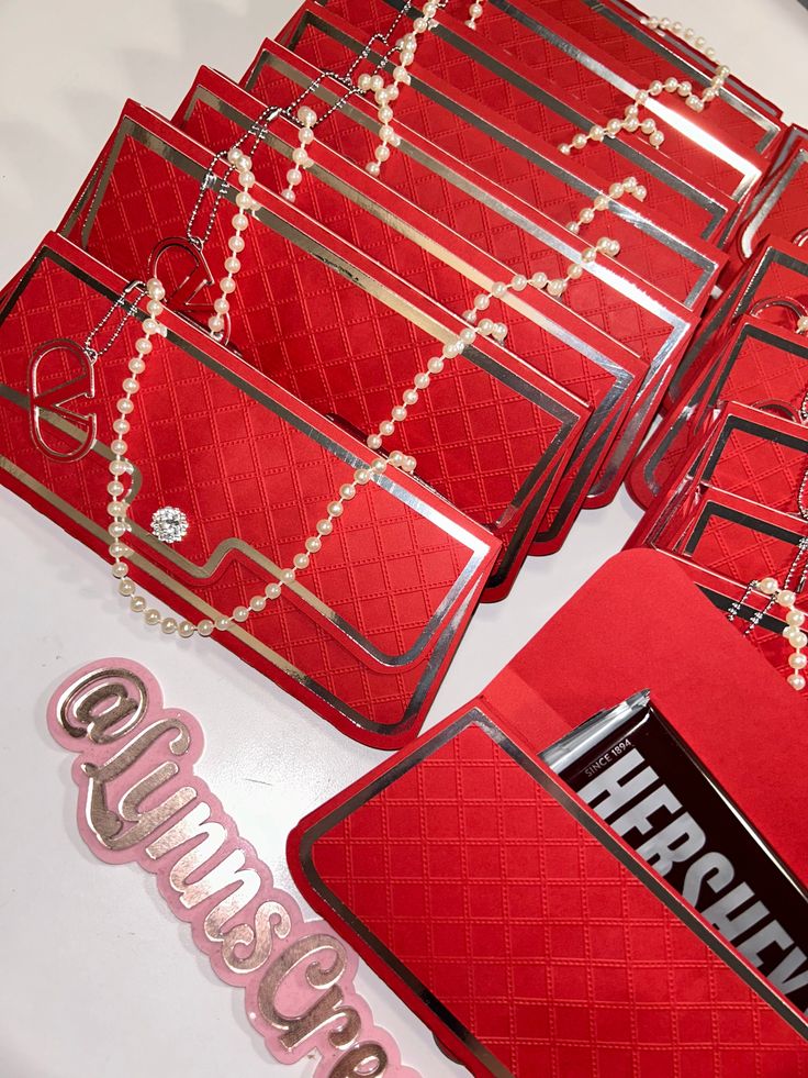 several red purses are on display with the word happily married spelled in silver letters