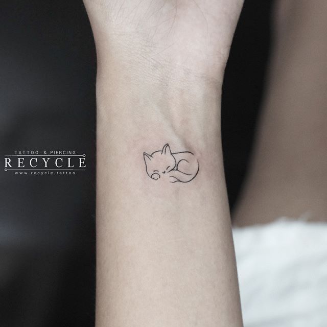 a small fox tattoo on the wrist