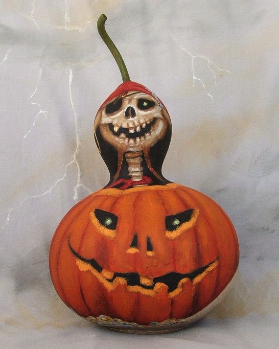 a carved pumpkin with a jack - o'- lantern on the top and an evil face