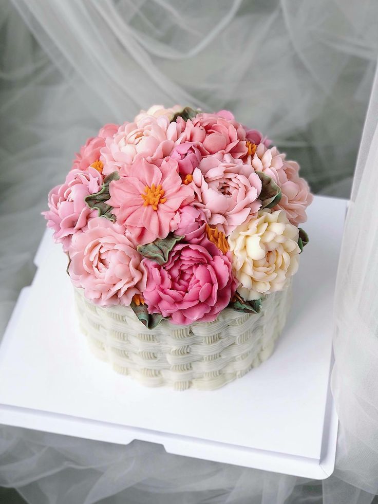 a cake decorated with pink and white flowers