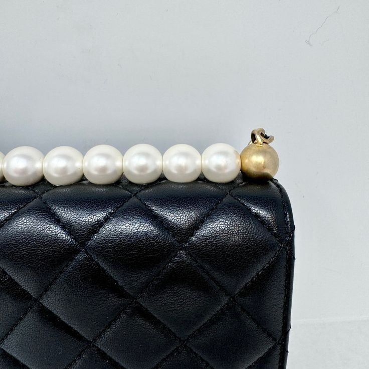 Chanel 2019 Quilted Small Chic Pearl Flap Bag with Interlocking CC Turn-lock and Gold-tone Hardware (with Dustbag) Designer = Chanel Color = Black Material = Leather Condition = Very Good Height = 6 Width = 8.5 Depth = 1.5 Class = Premier Location: Chicago Item Number: 19740-126 Item ID: 298142 Category: Shoulder Bag Classic Evening Bag With Lock, Classic Rectangular Bag With Pearl Handle, Classic Bag With Pearl Handle And Rectangular Shape, Elegant Satchel Flap Bag, Elegant Evening Shoulder Bag With Lock, Formal Clutch With Cc Turnlock Closure, High-end Shoulder Bag With Cc Turnlock For Evening, Formal Crossbody Shoulder Bag With Lock, Classic Evening Bag With Chain Strap And Top Handle