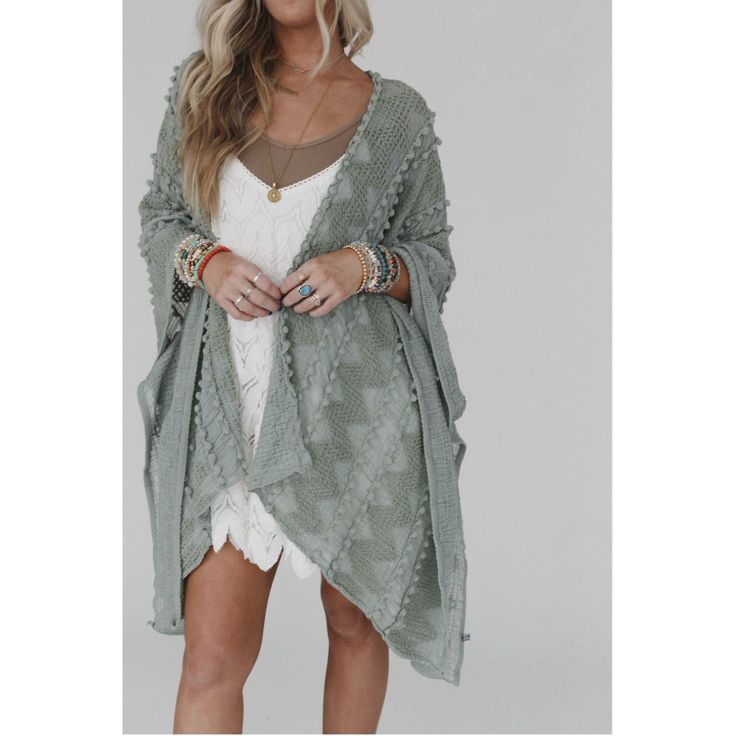 Elevate your wardrobe with the ultimate boho kimono! Designed in a lightweight, textured sage fabric and adorned with playful pom-pom details, this kimono effortlessly adds a touch of bohemian charm to any outfit. With an open front, poncho armhole sleeves, and side slits, it's the perfect combination of style and comfort. Embrace your free-spirited nature with the Bali Embroidered Kimono. Approximate measurements are as follows: OS: 45" x 31" One Size Fits Most *Due to lighting and differences Sage Fabric, Open Front Poncho, Embroidered Kimono, Boho Kimono, Beach Inspired, Free Spirited, Free Spirit, Front Open, Fabric Care