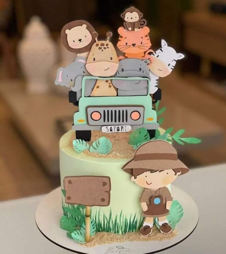 there is a cake with animals in the back of it on top of a table