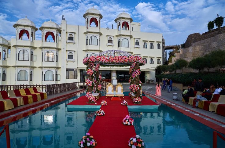 an outdoor ceremony set up in front of a large building