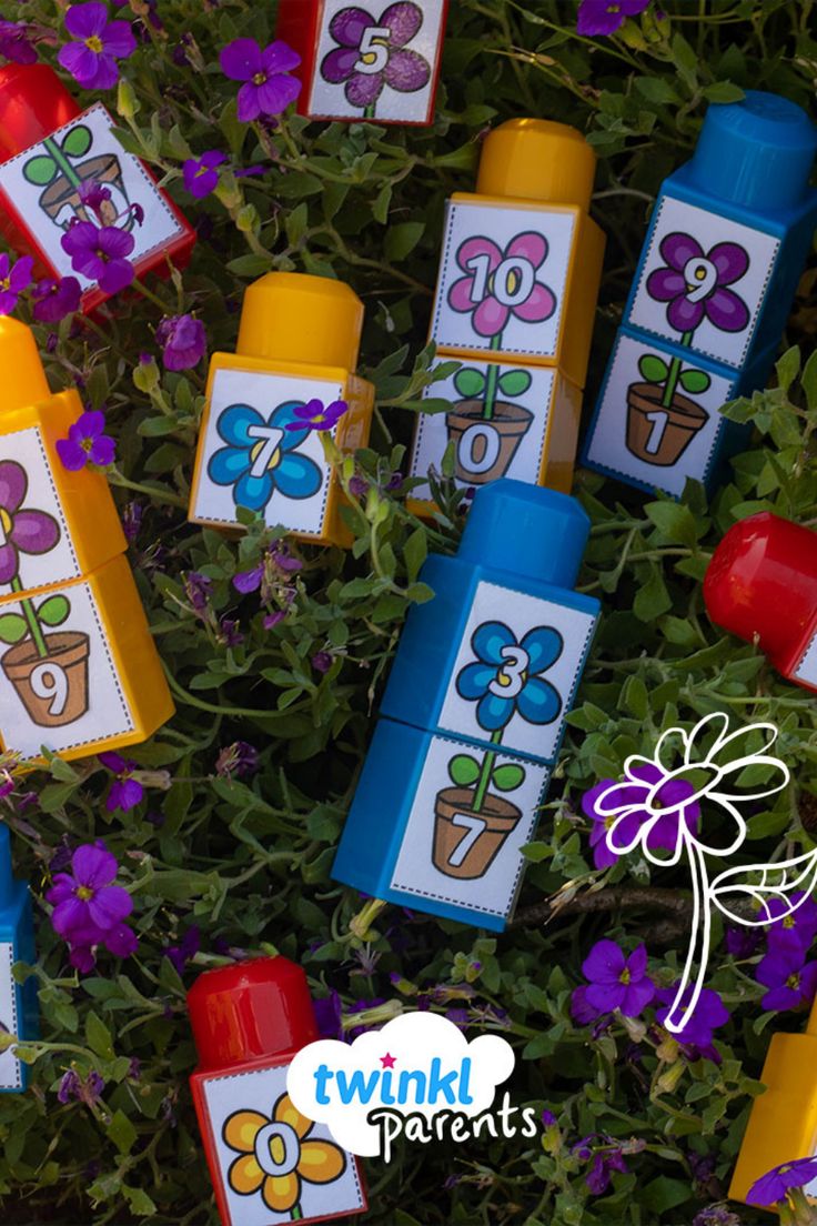 colorful crayon flowers and plants are in the grass