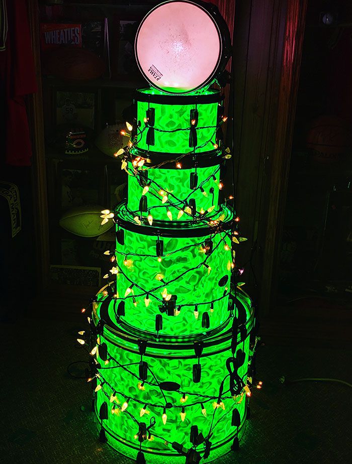 there is a large green cake with lights on it's top and bottom tier