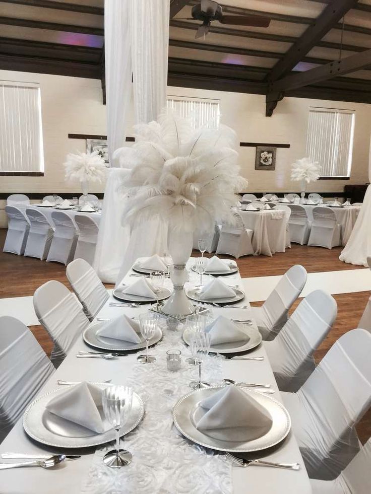 the tables are set with white linens and place settings for an elegant wedding reception