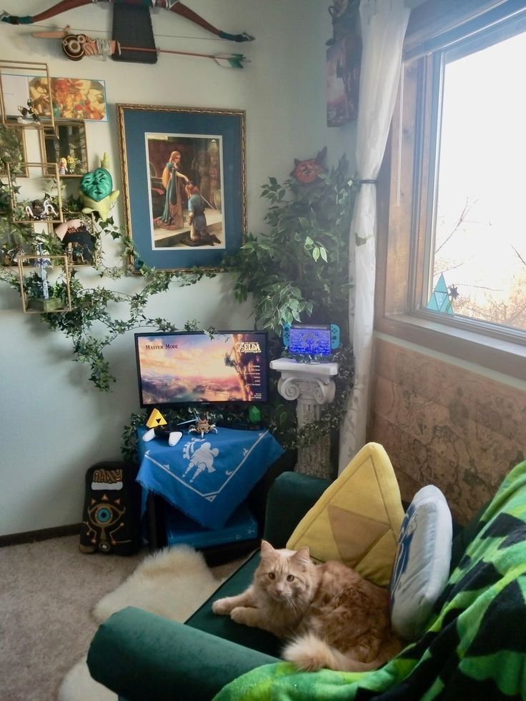 an orange cat laying on top of a green chair in front of a tv set