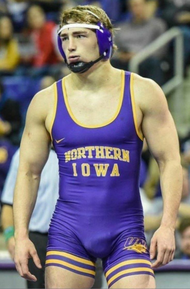 a wrestler wearing purple and yellow wrestling gear